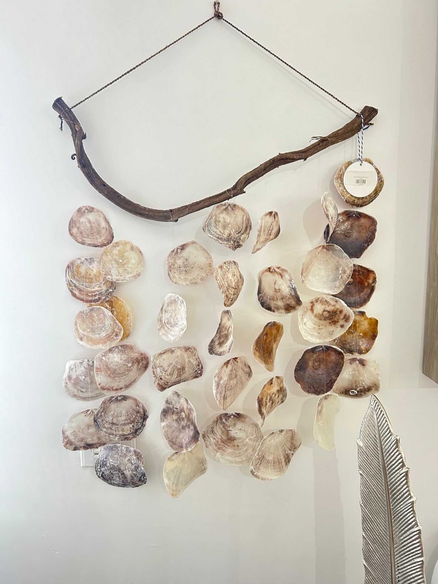 Natural wood and hanging shell art